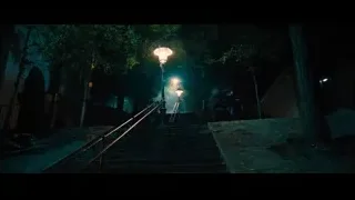 Person lying on dark stairs — John Wick: Chapter 4