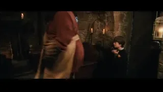 man speaking to people in dimly lit room — Harry Potter and the Philosophers Stone