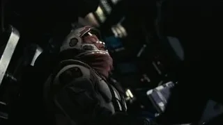 Man in helmet holding gun in dark room — Interstellar