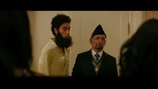 two men embracing in room — The Dictator