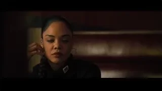 Young woman deep in thought in dim room — Creed 2