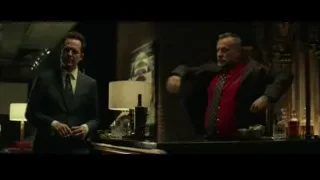 two men talking in a dimly lit bar — John Wick