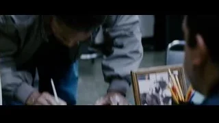 man in gray jacket looking at picture frame — The Persuit of Happyness
