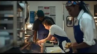 man and woman conversing in kitchen — The Bear
