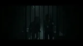 Person standing behind metal gate in dark room — Harry Potter and the Deathly Hallows 2