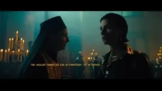priest and woman in dimly lit room — John Wick: Chapter 4