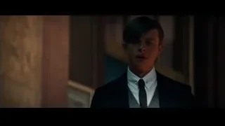 young man in suit standing in dimly lit room — The Amazing Spider Man 2