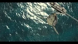 Large fish hanging from rope in ocean — Jurassic World