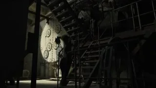 Large clock hanging in dilapidated room with staircase — Blade Runner 2049