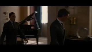 Two men in suits in a hallway — Batman: The Dark Knight Rises