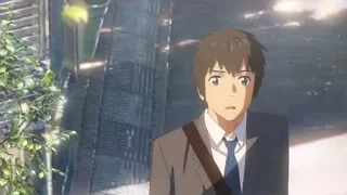 young man in suit in front of building — Your Name