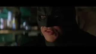 Batman looking at camera in dimly lit room — Batman