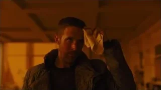 Man wiping face with cloth in dimly lit room — Blade Runner 2049