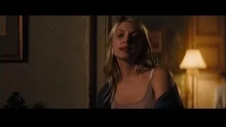 blonde woman in tank top in dim room — Now You See Me