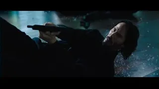 man lying on floor holding gun — John Wick: Chapter 4