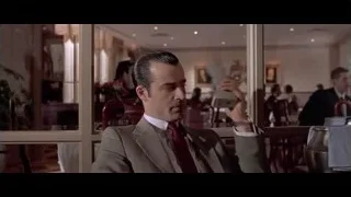 man in suit looking at tablet in restaurant — American Psycho