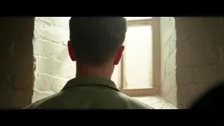 man looking out window in dimly lit room — Hacksaw Ridge