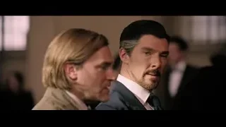 two men deep in thought in formal setting — Doctor Strange 2