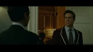 Two men in suits in hallway — The Social Network