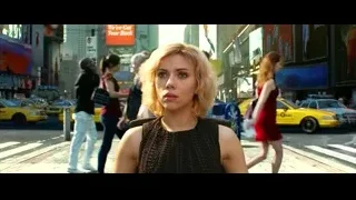 young woman on busy city street — Lucy