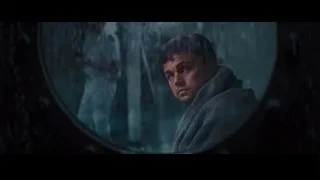 man looking out round window — The Wolf Of Wall Street
