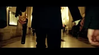 person holding gun in hallway — Lucy
