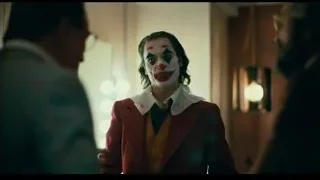 Joker in red suit with two men — Joker
