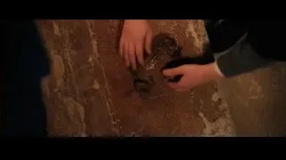 young boy examining object in dark room — Harry Potter and the Philosophers Stone