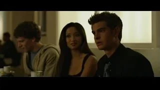 three young people sitting at dimly lit table — The Social Network