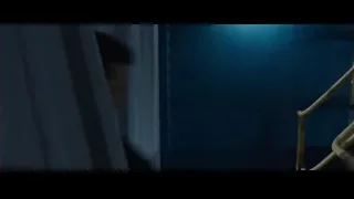Man walking down dark industrial hallway — Iron Man 3