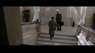 Two men walking down luxurious staircase — Batman
