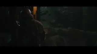 Bald man in dimly lit room with stone wall — Iron Man