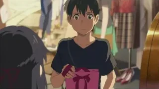serious boy holding pink gift box — Weathering with You