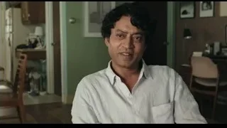 Man sitting in living room with kitchen — Life of Pi