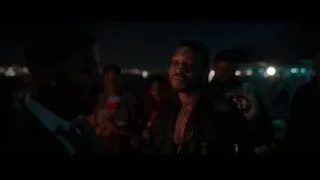 people around campfire on beach at night — Creed 3