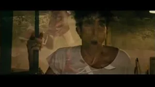 Young man holding metal pole in dim room — The Dictator