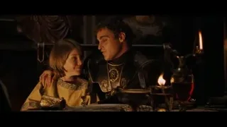 man and woman at table with candles — Gladiator