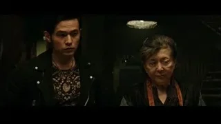 Man and elderly woman in dimly lit room — Now You See Me 2