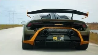black and orange Lamborghini driving on road — Sports Cars