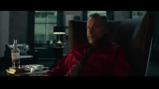 man in armchair with whiskey bottle — John Wick