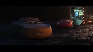 Cars characters driving on dirt road at night — Cars 3