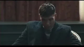 young man sitting at desk in dark room — Peaky Blinders