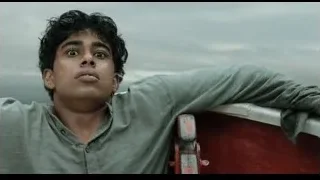 young man in boat with arms stretched out — Life of Pi