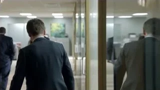 Four men in suits walking in office corridor — Suits
