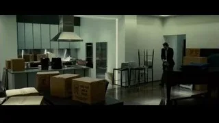 man in suit in modern kitchen with boxes — Limitless
