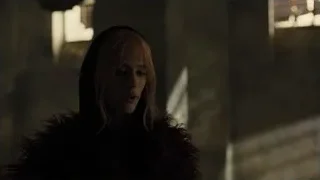 Woman in fur coat in dimly lit room — Blade Runner 2049