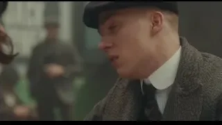 Man in beret talking with woman outdoors — Peaky Blinders