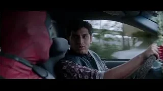 man in Deadpool mask driving car in rain — Deadpool