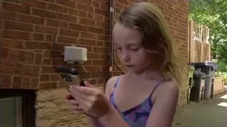 young girl in swimsuit looking at phone — Screened Out