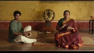 Man and woman playing tabla in yellow room — Life of Pi